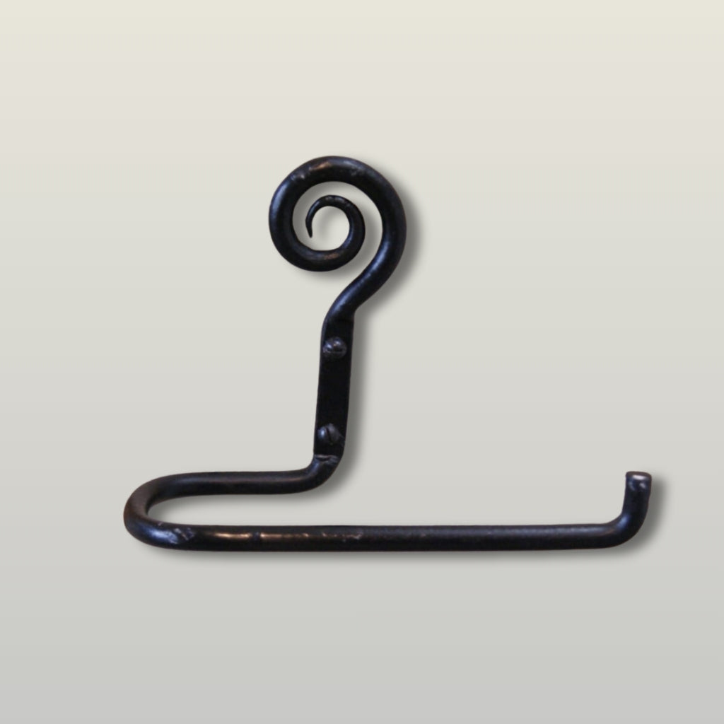 A dark, rustic hand-forged metal hook with a spiral top and a flat horizontal arm, shown against a light beige background.
